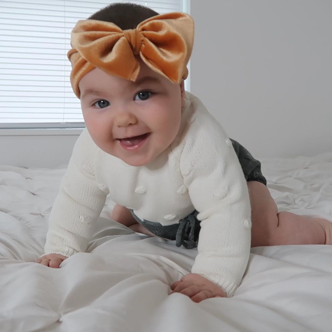 cute baby girl with a bow in the head