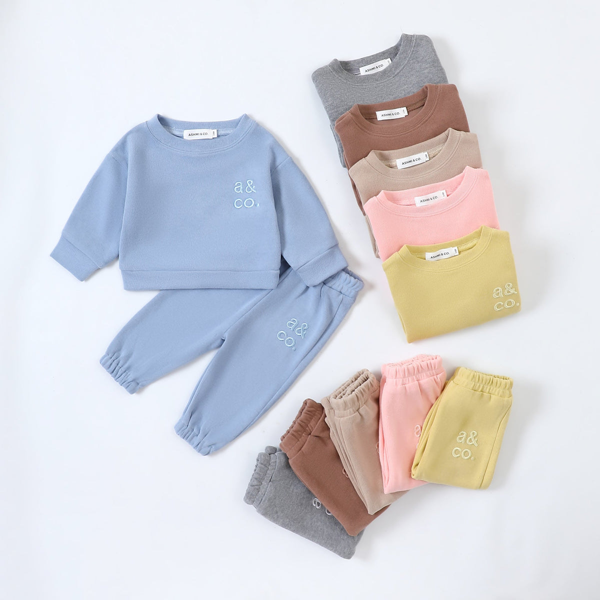 Ashmi Signature Sets in blue, yellow, pink and neutrals with embroidered a&co. logo